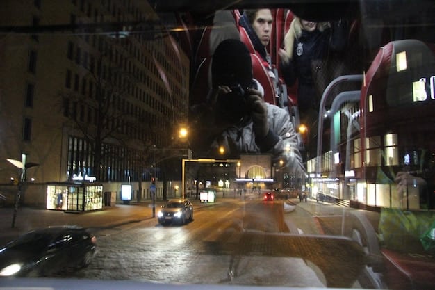 A dynamic action scene from a Korean action movie, featuring a car chase in a bustling city with neon lights.
