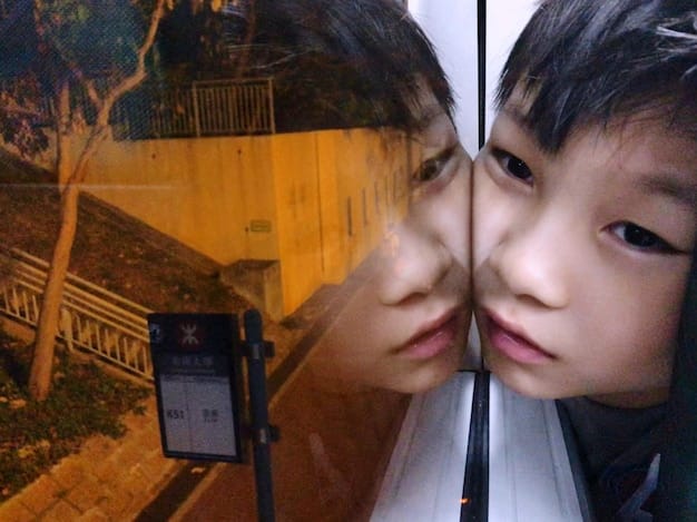 A split image comparing a scene from a K-drama where the characters are having a dramatic, tearful confession of love, against a real-life couple having a calm, intimate conversation on a park bench, showcasing the contrast between exaggerated emotion and realistic interaction.