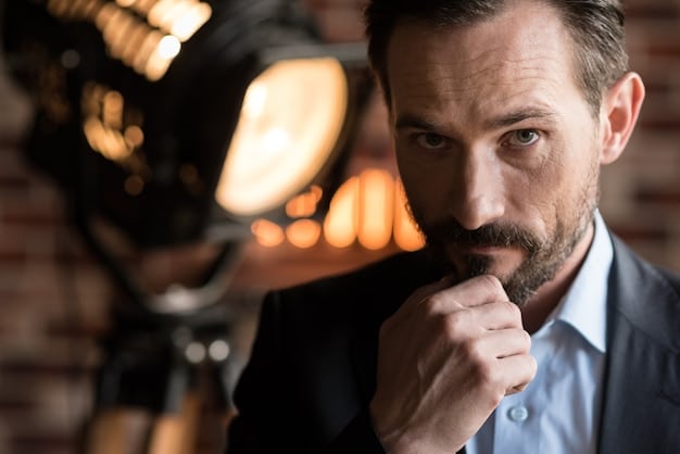 A close-up image of a casting director thoughtfully reviewing headshots of aspiring actors, with a script and a cup of coffee on the desk, capturing the intense decision-making process.