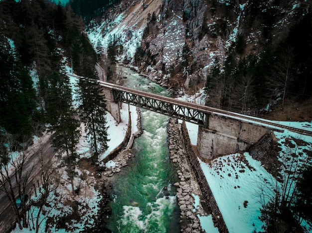 A scenic view of the Crash Landing on You set in Switzerland, showcasing the beautiful wooden bridge where the main characters share a significant moment. The image should focus on the romantic atmosphere and the serene landscape.
