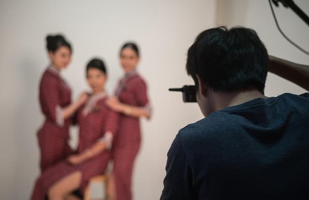 A behind-the-scenes photo of a Korean drama set, showing actors practicing their lines and the crew preparing for a scene.